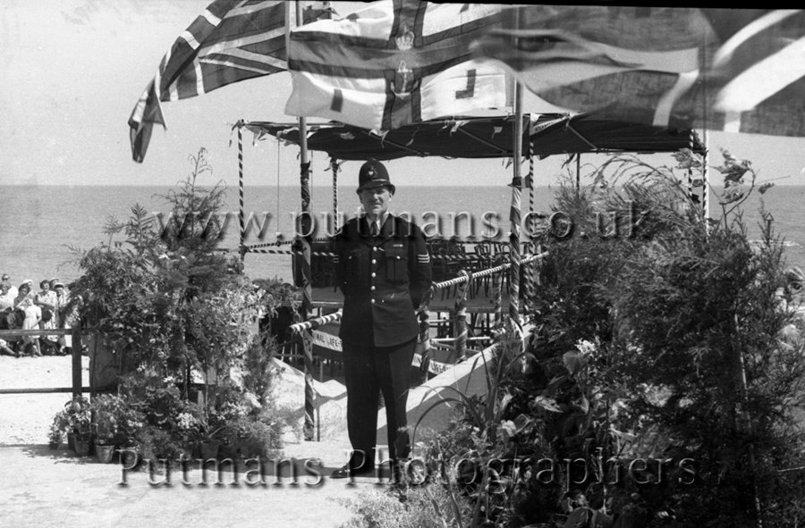 Ref 74 One lone policeman (Sgt. Jennings) guards the podium