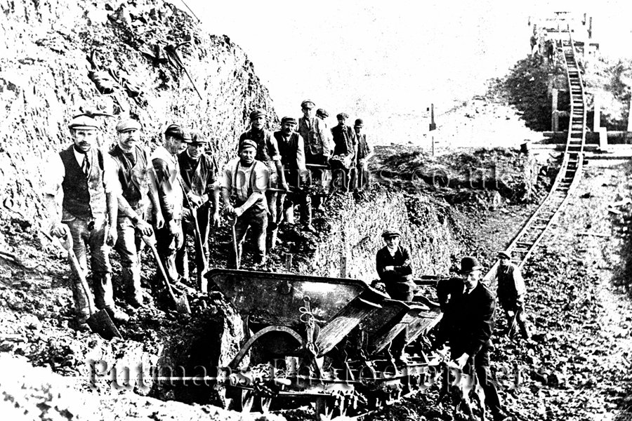 Ref 1285 Gang of men building either a breakwater or the first pier