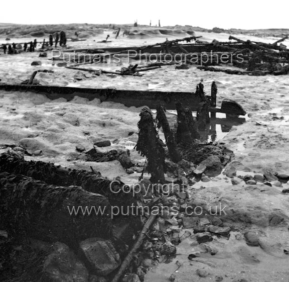 Ref 2019 Ancient wooden structure uncovered by sea at The Low 1963