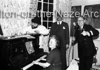 Michael Hipkin, Mick Berry and unknown bus driver. Mrs Edmonds at the piano. 31-12-1962