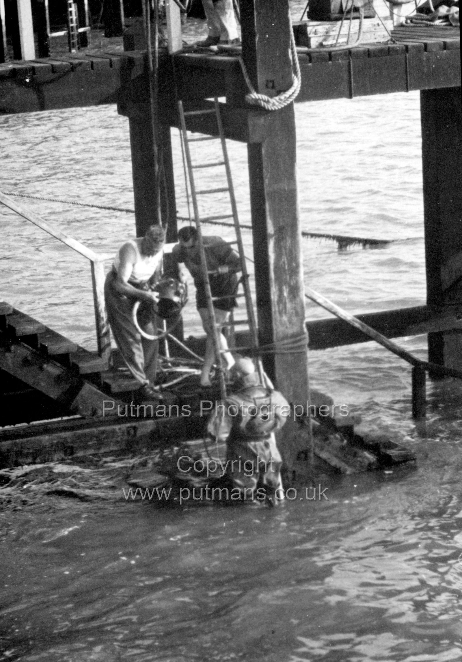 Ref 3040 Diver inspecting pier c1945