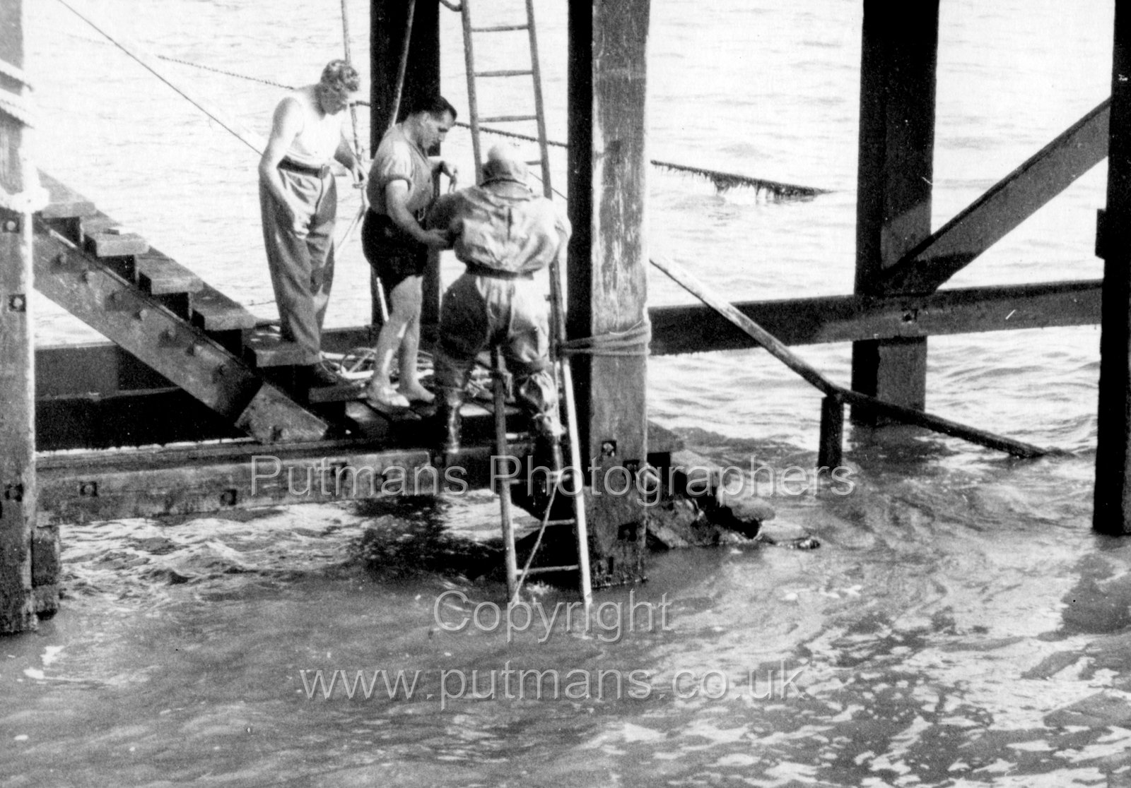 Ref 3043 Diver inspecting pier c1945