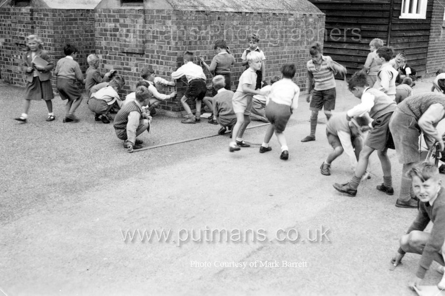 Ref D5 Children measuring dimensions of playground c1955