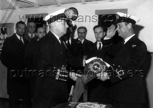 Sea Cadet Capt Dunn presenting pennant award to Charles Keen
